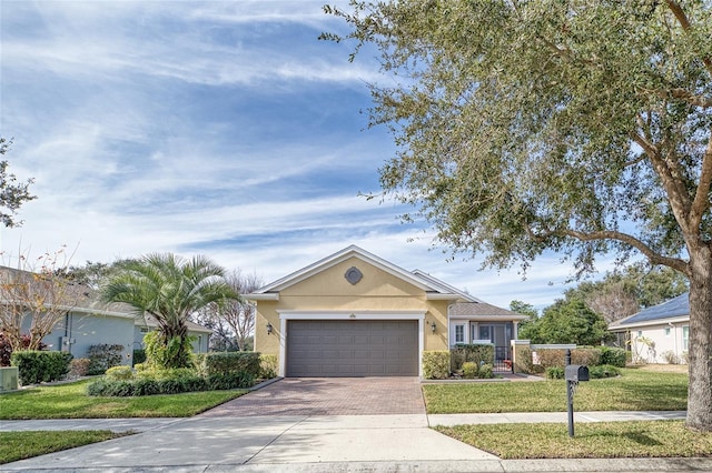 370 Salt Marsh Ln, Groveland, FL 34736 - single story home with decorative driveway, a garage, a front yard, and stucco siding