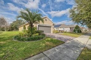370 Salt Marsh Ln, Groveland, FL 34736 - view of front of home with driveway, a front lawn, and an attached garage