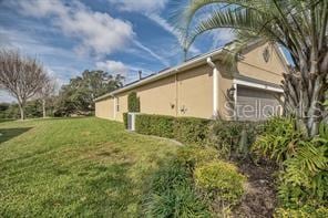 370 Salt Marsh Ln, Groveland, FL 34736 - view of side of home featuring stucco siding and a lawn