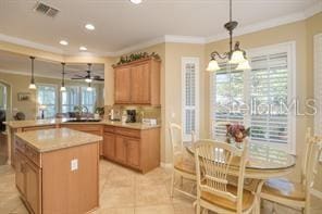 370 Salt Marsh Ln, Groveland, FL 34736 - kitchen featuring crown molding, ceiling fan, a peninsula, light countertops, and hanging light fixtures