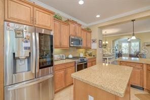 370 Salt Marsh Ln, Groveland, FL 34736 - kitchen featuring stainless steel appliances, a center island, hanging light fixtures, crown molding, and recessed lighting