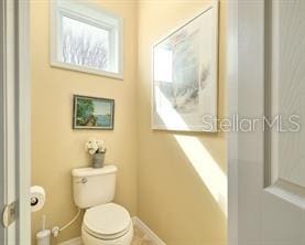 370 Salt Marsh Ln, Groveland, FL 34736 - bathroom with toilet and baseboards