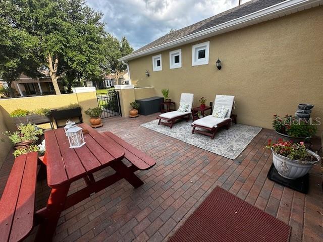 370 Salt Marsh Ln, Groveland, FL 34736 - view of patio / terrace featuring a gate and outdoor dining space