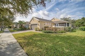 370 Salt Marsh Ln, Groveland, FL 34736 - view of front facade featuring a garage, a front yard, and concrete driveway