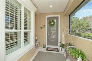 370 Salt Marsh Ln, Groveland, FL 34736 - view of exterior entry with stucco siding