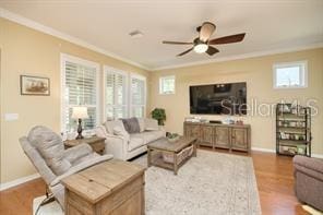 370 Salt Marsh Ln, Groveland, FL 34736 - living area with ornamental molding, wood finished floors, and a ceiling fan