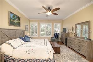 370 Salt Marsh Ln, Groveland, FL 34736 - bedroom with ornamental molding, wood finished floors, and a ceiling fan
