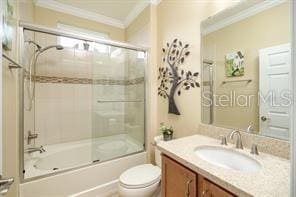 370 Salt Marsh Ln, Groveland, FL 34736 - full bathroom featuring ornamental molding, vanity, and bath / shower combo with glass door