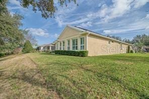 370 Salt Marsh Ln, Groveland, FL 34736 - view of side of home featuring a yard