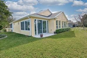 370 Salt Marsh Ln, Groveland, FL 34736 - back of property with a yard and stucco siding