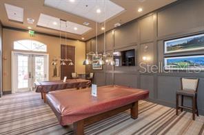 370 Salt Marsh Ln, Groveland, FL 34736 - recreation room with carpet, pool table, a towering ceiling, a decorative wall, and recessed lighting