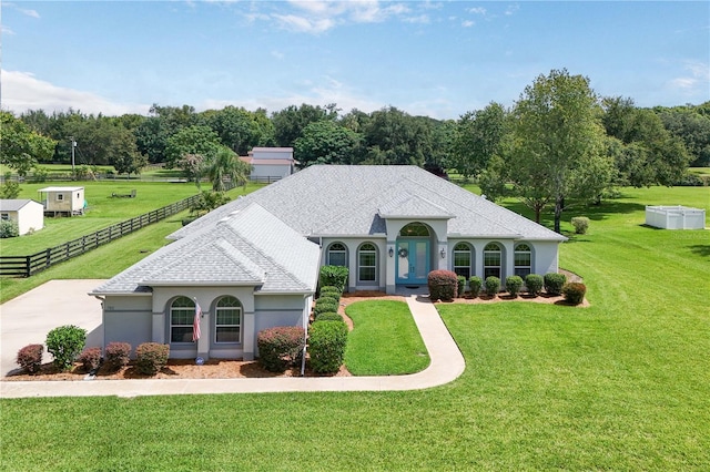 7811 Laurel View Dr, Mount Dora, FL 32757 - french provincial home featuring stucco siding, roof with shingles, and view of wooded area
