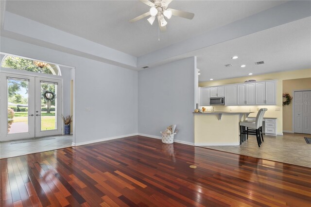 7811 Laurel View Dr, Mount Dora, FL 32757 - unfurnished living room with hardwood / wood-style flooring, a ceiling fan, french doors, and recessed lighting