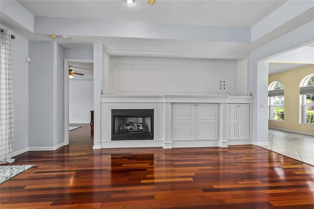 7811 Laurel View Dr, Mount Dora, FL 32757 - unfurnished living room featuring wood finished floors, ceiling fan, and a fireplace