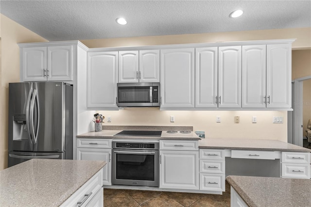 7811 Laurel View Dr, Mount Dora, FL 32757 - kitchen featuring stainless steel appliances, white cabinetry, a textured ceiling, light stone countertops, and recessed lighting
