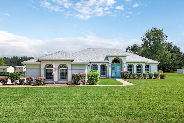 7811 Laurel View Dr, Mount Dora, FL 32757 - mediterranean / spanish home featuring stucco siding, a front lawn, and roof with shingles