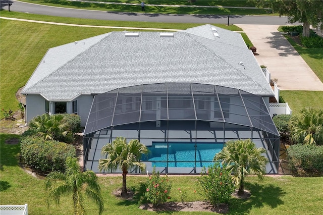 7811 Laurel View Dr, Mount Dora, FL 32757 - rear view of house with glass enclosure, a yard, roof with shingles, and an outdoor pool