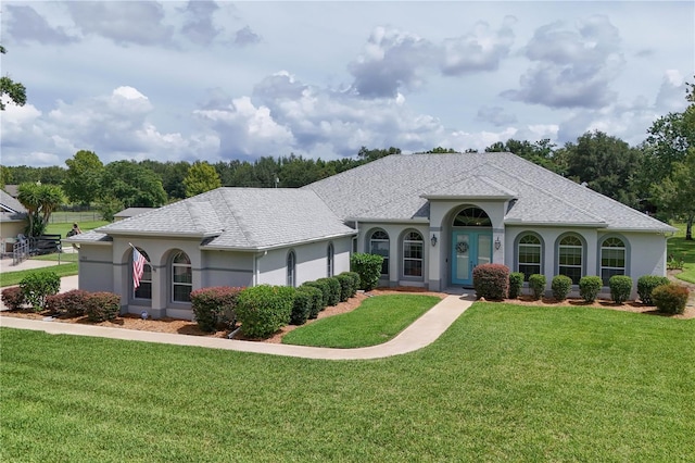 7811 Laurel View Dr, Mount Dora, FL 32757 - view of front of property featuring a front lawn, stucco siding, and roof with shingles