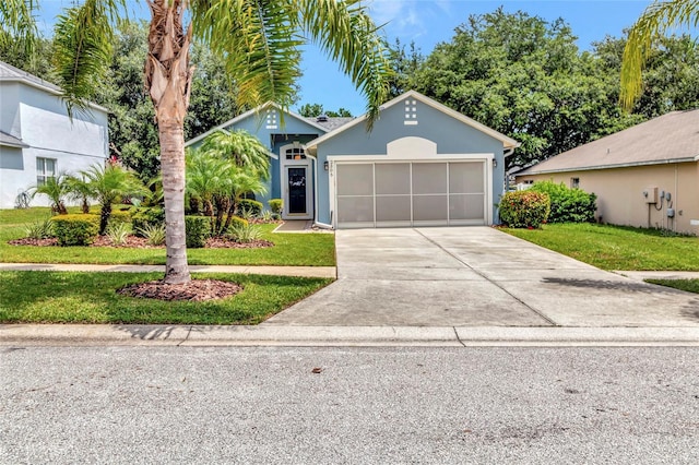 2305 Foxtree Rd, Tavares, FL 32778 - ranch-style house featuring concrete driveway, a garage, a front yard, and stucco siding