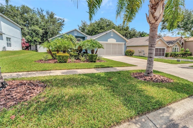 2305 Foxtree Rd, Tavares, FL 32778 - view of front of house featuring driveway, a front yard, a garage, and stucco siding