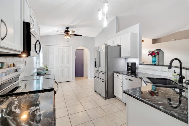 2305 Foxtree Rd, Tavares, FL 32778 - kitchen with appliances with stainless steel finishes, arched walkways, ceiling fan, decorative backsplash, and vaulted ceiling