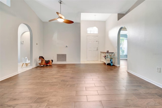 2305 Foxtree Rd, Tavares, FL 32778 - foyer entrance with arched walkways, high vaulted ceiling, and ceiling fan