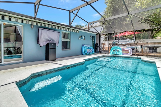 2305 Foxtree Rd, Tavares, FL 32778 - swimming pool with a patio area and glass enclosure