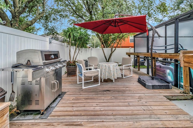 2305 Foxtree Rd, Tavares, FL 32778 - wooden terrace featuring a fenced backyard, area for grilling, and outdoor dining space