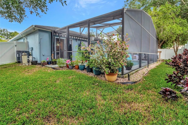 2305 Foxtree Rd, Tavares, FL 32778 - rear view of property featuring a fenced backyard, a lanai, a gate, and stucco siding