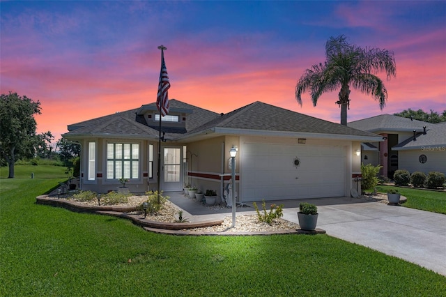 6307 Berkshire Pass, Leesburg, FL 34748 - view of front of home featuring stucco siding, an attached garage, a front lawn, driveway, and roof with shingles