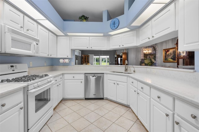6307 Berkshire Pass, Leesburg, FL 34748 - kitchen featuring white appliances, light tile patterned floors, light countertops, white cabinets, and a chandelier