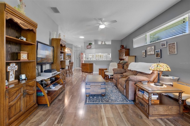 6307 Berkshire Pass, Leesburg, FL 34748 - living area featuring a ceiling fan, healthy amount of natural light, wood finished floors, and recessed lighting