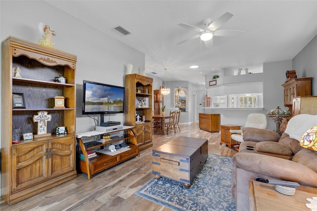 6307 Berkshire Pass, Leesburg, FL 34748 - living area featuring light wood finished floors and ceiling fan