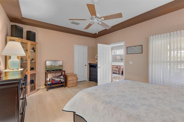 6307 Berkshire Pass, Leesburg, FL 34748 - bedroom featuring light wood-style flooring and ceiling fan