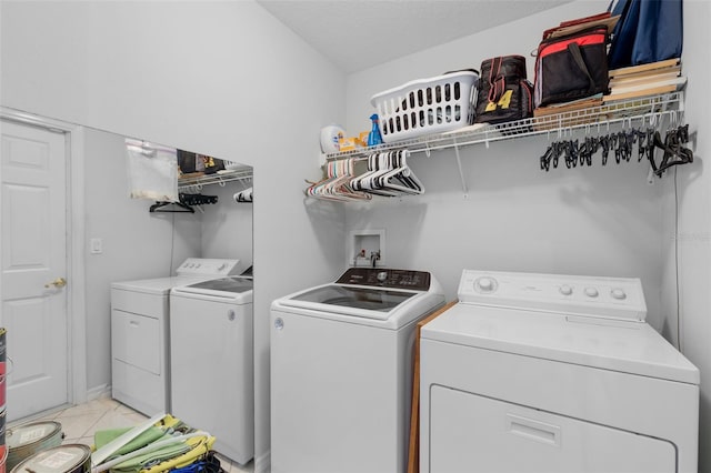 6307 Berkshire Pass, Leesburg, FL 34748 - laundry area featuring washer and clothes dryer and light tile patterned floors