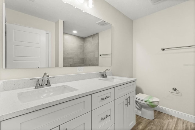 671 E Toledo Dr, Citrus Springs, FL 34434 - full bath with wood finished floors, double vanity, and a tile shower