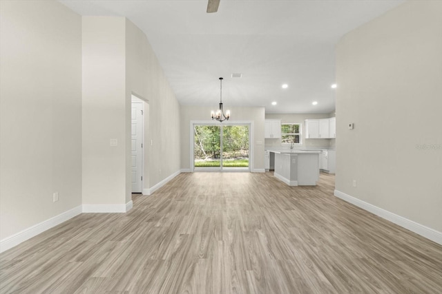 671 E Toledo Dr, Citrus Springs, FL 34434 - unfurnished living room featuring a chandelier, light wood-style floors, recessed lighting, and a ceiling fan