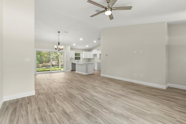 671 E Toledo Dr, Citrus Springs, FL 34434 - unfurnished living room with a chandelier, lofted ceiling, ceiling fan, light wood-style flooring, and recessed lighting