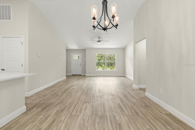 671 E Toledo Dr, Citrus Springs, FL 34434 - unfurnished living room featuring a chandelier, light wood-style floors, and a ceiling fan