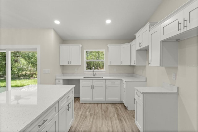 671 E Toledo Dr, Citrus Springs, FL 34434 - kitchen featuring white cabinetry, light wood-type flooring, light stone counters, and recessed lighting