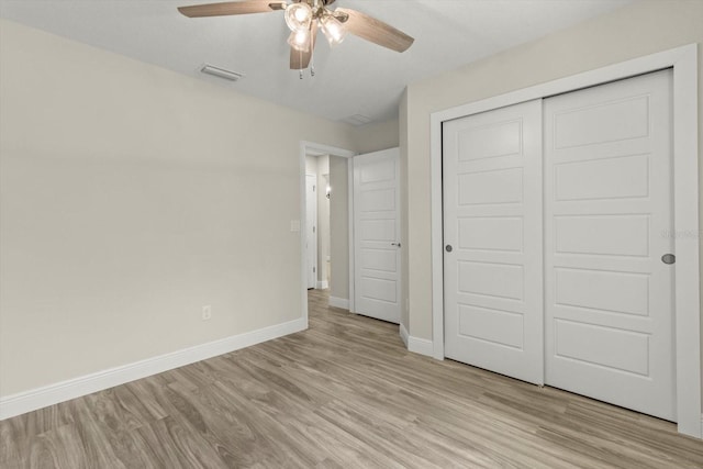 671 E Toledo Dr, Citrus Springs, FL 34434 - unfurnished bedroom with light wood-type flooring, a closet, and ceiling fan