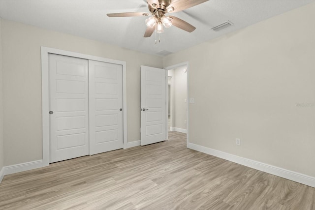 671 E Toledo Dr, Citrus Springs, FL 34434 - unfurnished bedroom with light wood finished floors, a closet, and ceiling fan