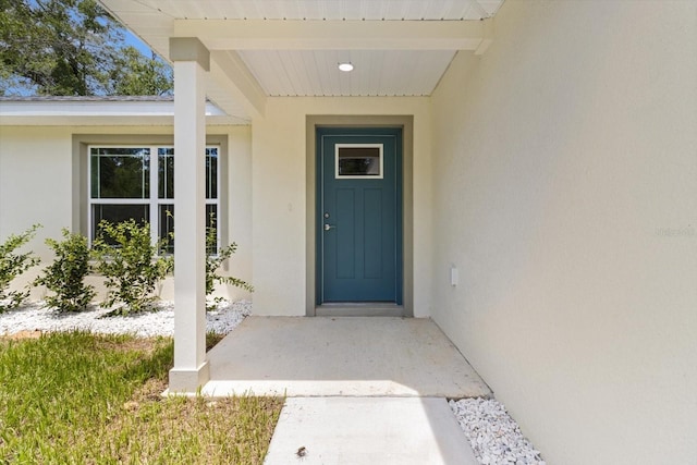 671 E Toledo Dr, Citrus Springs, FL 34434 - doorway to property featuring stucco siding