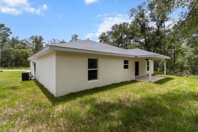 671 E Toledo Dr, Citrus Springs, FL 34434 - back of property with a patio, stucco siding, a yard, ceiling fan, and roof with shingles