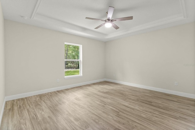 671 E Toledo Dr, Citrus Springs, FL 34434 - unfurnished room featuring a raised ceiling, light wood-style floors, a ceiling fan, and a smoke detector