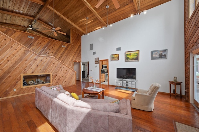7201 SW 97th Ln, Gainesville, FL 32608 - living area featuring ceiling fan, high vaulted ceiling, a wood ceiling with exposed beams, wooden walls, and hardwood / wood-style floors