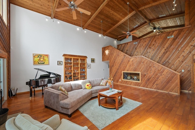 7201 SW 97th Ln, Gainesville, FL 32608 - living area featuring high vaulted ceiling, ceiling fan, wood walls, a wooden ceiling with exposed beams, and hardwood / wood-style floors