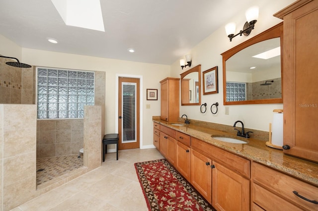 7201 SW 97th Ln, Gainesville, FL 32608 - bathroom with a skylight, walk in shower, double vanity, tile patterned floors, and recessed lighting