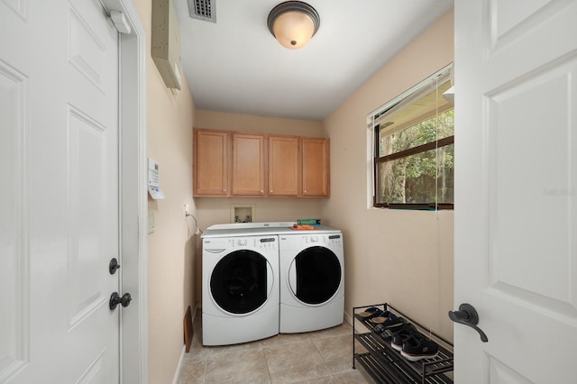 7201 SW 97th Ln, Gainesville, FL 32608 - washroom with independent washer and dryer, cabinet space, and light tile patterned flooring