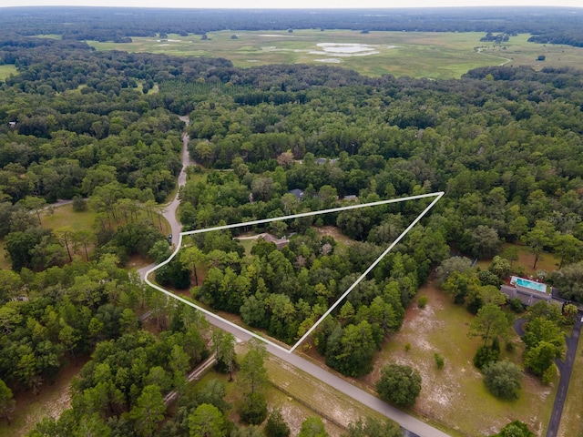 7201 SW 97th Ln, Gainesville, FL 32608 - aerial view of property and surrounding area featuring a heavily wooded area and property boundaries highlighted